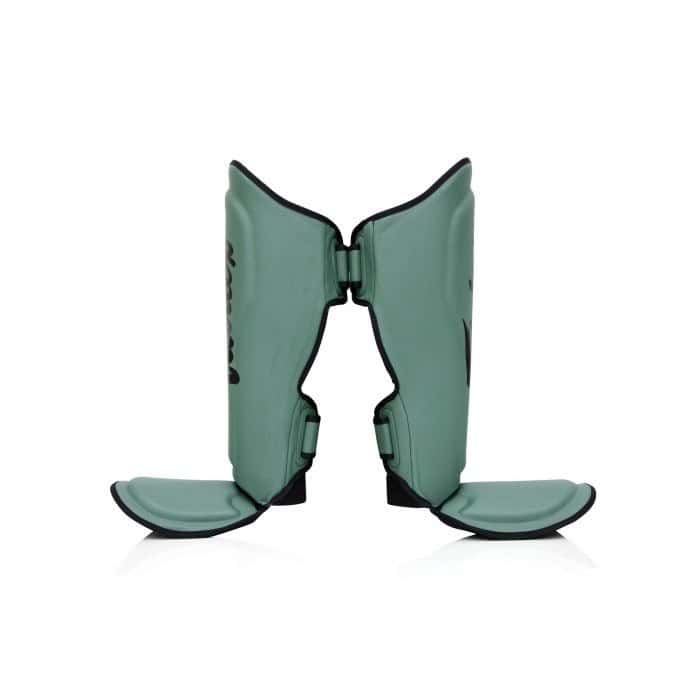 Zijaanzicht van de Booster FXB SG scheenbeschermers in groen. De stevige padding en ergonomische pasvorm zorgen voor maximale bescherming en stabiliteit tijdens intensieve kickbokstrainingen, met dubbele klittenbandsluiting voor een veilige fit.