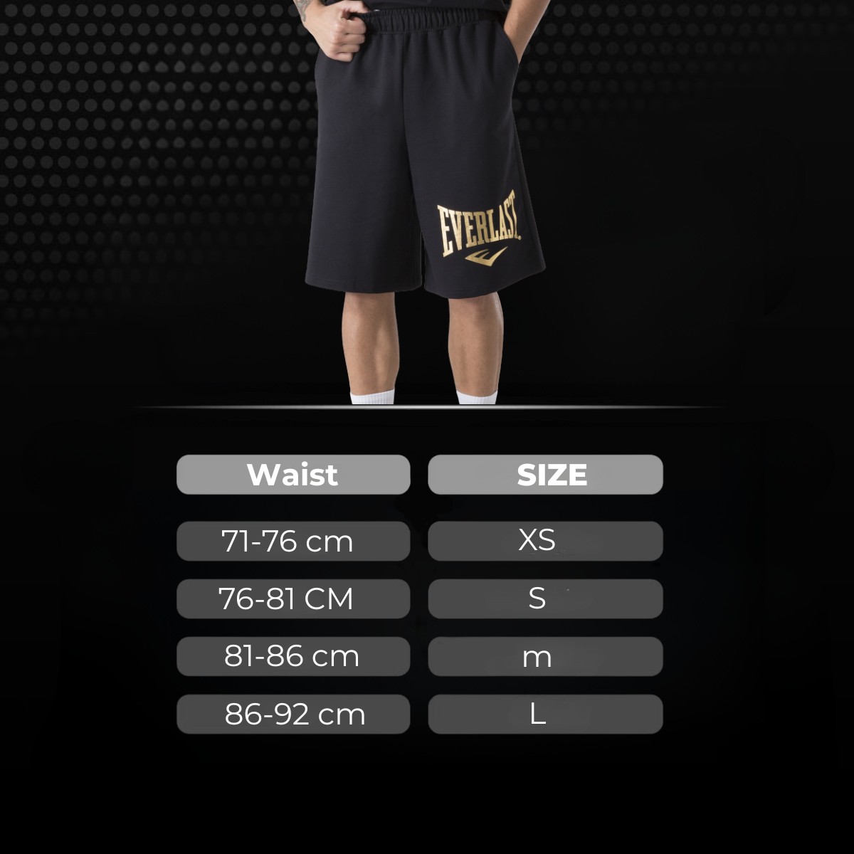Maattabel voor de zwarte Everlast sportshort met goudkleurig logo en tailleomtrek voor maten XS tot L. De afbeelding helpt boksers en kickboksers de juiste maat te kiezen voor trainingen.