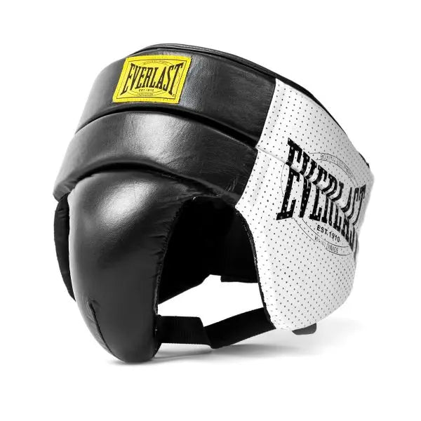 Side view of Everlast boxing headguard in black and white with padded cheek and forehead protection. The image highlights the durable outer material, breathable perforated side panels, adjustable chin strap, and classic Everlast logo, designed for comfort, protection, and visibility during boxing training and sparring.