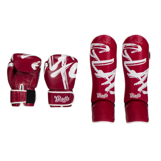 Complete set of Gladts boxing gloves and shin guards in bordeaux red, displayed side by side on a white background. The set features white graphic details, padded gloves with Velcro wrist closure, and matching shin guards designed for boxing and kickboxing training.