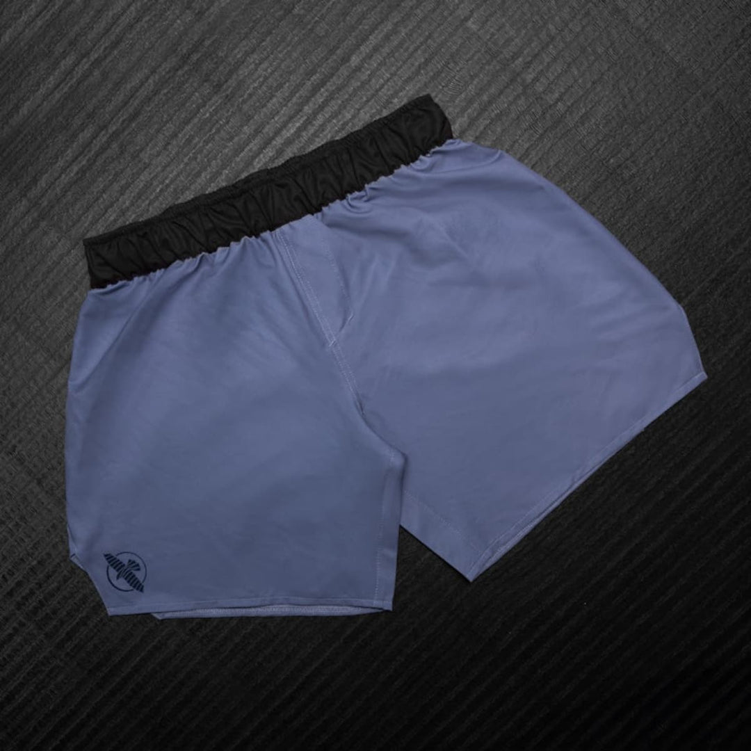 Hayabusa MMA Shorts Heren Core Blauw liggend gefotografeerd met volledig overzicht van het strakke ontwerp.