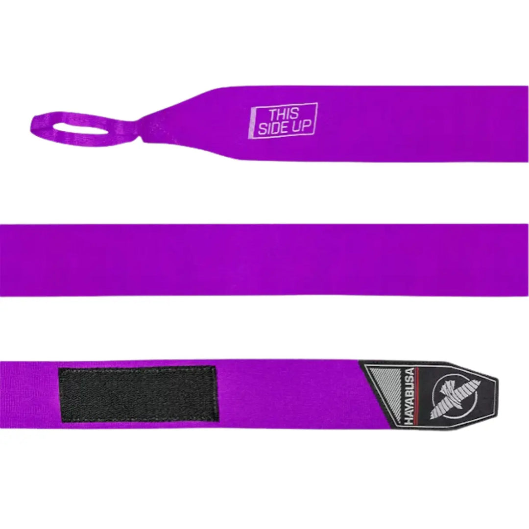 Uitgerolde paarse Hayabusa Perfect Stretch bandage met duimlus, “This Side Up”-markering en zwart klittenband, duidelijk zichtbaar op een witte achtergrond voor productweergave.