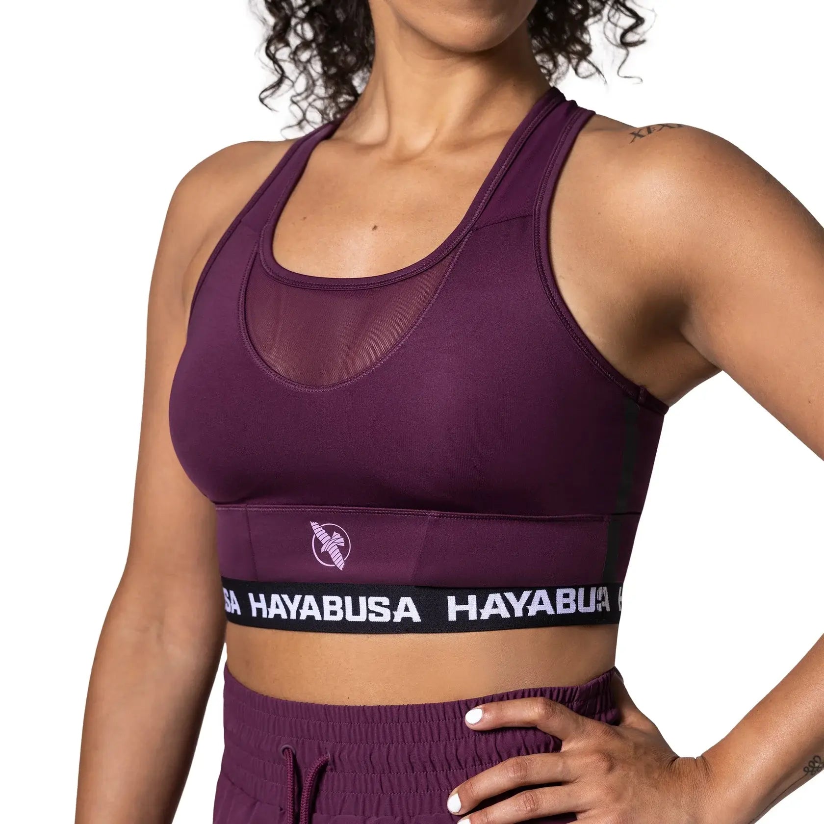 Hayabusa women’s sports bra in deep purple with racerback design and wide elastic underband for secure support. Designed for comfort, stability, and freedom of movement during intense training and workouts.