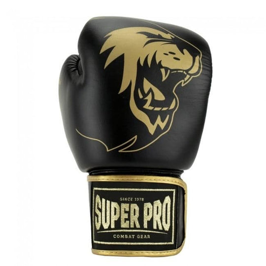 Een zwarte bokshandschoen met een groot, goudkleurig leeuwenlogo en het goudkleurige Super Pro Combat Gear logo op de polssluiting.