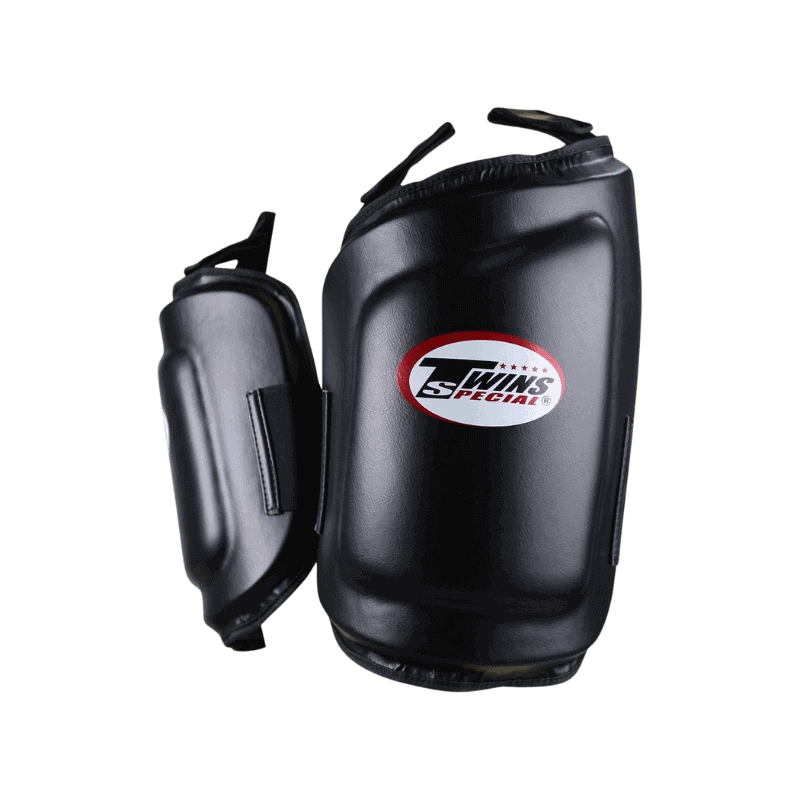 Zijkant van de Twins Special beenbeschermers, toont de dikte en beschermende lagen van de padding. Het logo is goed zichtbaar in het midden.