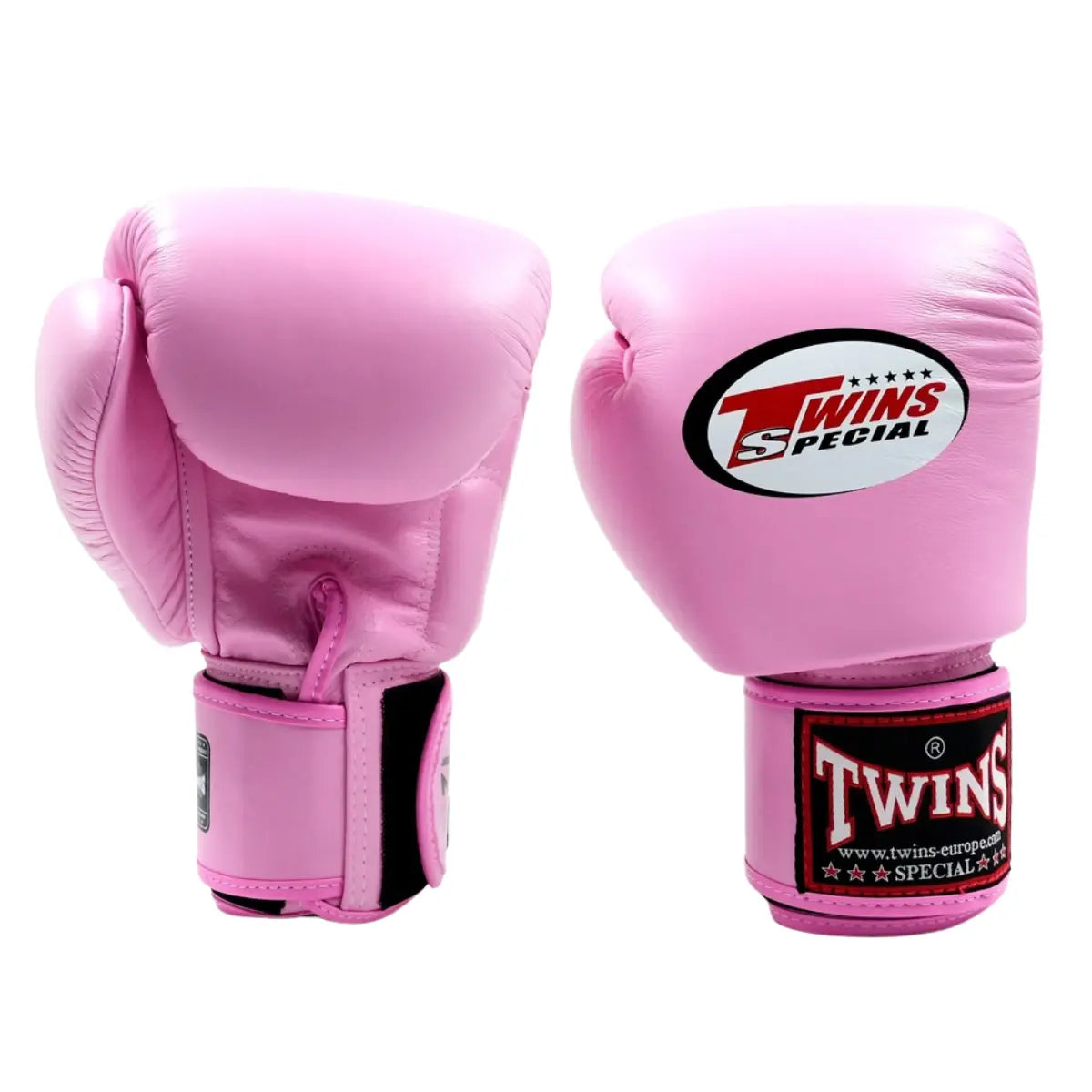 De Twins Bokshandschoenen Roze BGVL3 staan rechtop naast elkaar op een witte achtergrond. De handschoenen hebben een opvallende roze kleur met het kenmerkende Twins Special-logo op de bovenkant en op de stevige polssluiting. De gladde leren afwerking en het ergonomische ontwerp benadrukken de combinatie van stijl, comfort en bescherming voor intensieve bokstrainingen.
