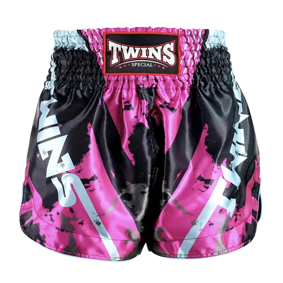 Twins Special Muay Thai shorts in pink and black with light blue accents, featuring an elastic waistband and bold graphic design. The shorts are made for unrestricted movement and comfort during Muay Thai and kickboxing training sessions.
