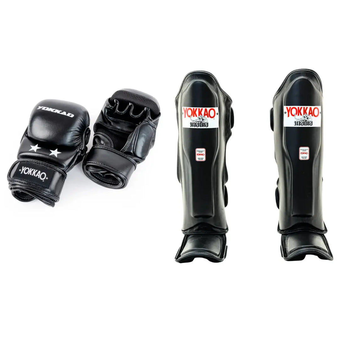 A professional martial arts gear bundle featuring black leather MMA sparring gloves with open palms and matching contoured black shin guards. All items prominently display the white and red YOKKAO brand logo.
