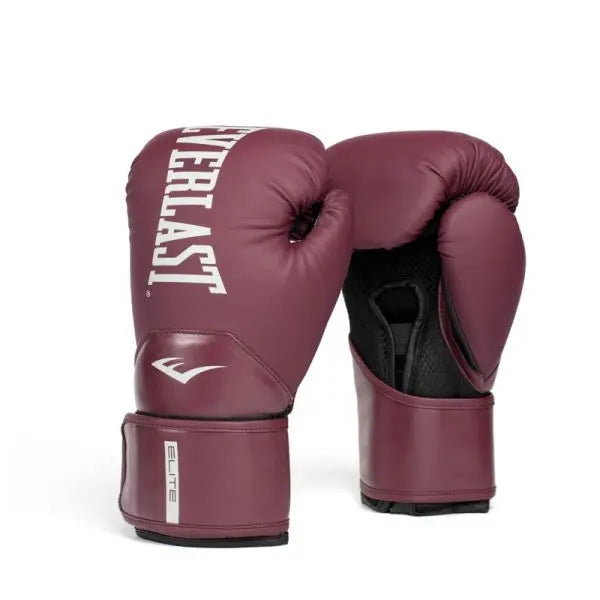 Vooraanzicht van de Everlast Elite bokshandschoenen in een diepe bordeauxkleur met contrasterende witte branding. Het krachtige Everlast-logo op de knokkelzijde en de subtiele “Elite”-detail op de polsband geven de handschoenen een professionele uitstraling. De brede klittenbandsluiting zorgt voor stevige polsondersteuning tijdens intensieve bokstrainingen. De combinatie van luxe kleur, strakke afwerking en ademende binnenzijde maakt deze handschoenen ideaal voor serieuze sessies in de gym.